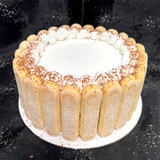 Each cake is adorned with lady fingers and cocoa powder. 